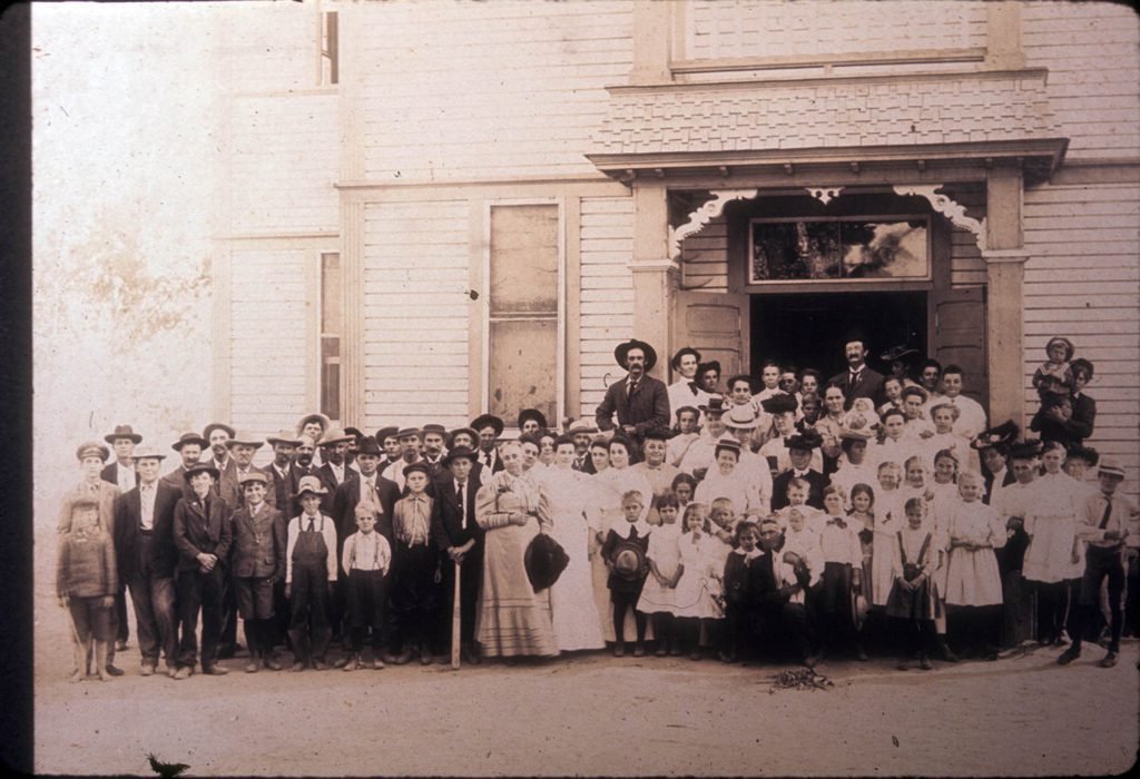A group portrait at an unidentified gathering at La Habra School, located on Central Avenue, La Habra, Calif., in 1908. The school was built in 1896 and was used for classes and community events. It was later renamed La Habra Grammar School and replaced with a new building in 1915.