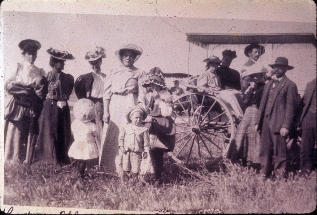 Swiss-American settlers John Luehm, Jacob Leutwiler, and Fred X. Thuet and their families on an outing to the La Habra Valley. The three families were among a group of settlers who moved from Highland, Illinois to the La Habra area in the 1890s. Photograph date circa 1890s.